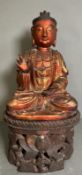 A carved Buddha on carved stand in red and gilt, some damage but additional pieces present for