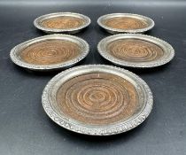 A set of five Sterling silver and wooden coasters.