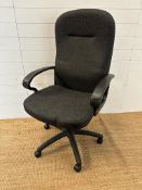 A black adjustable office chair on castors