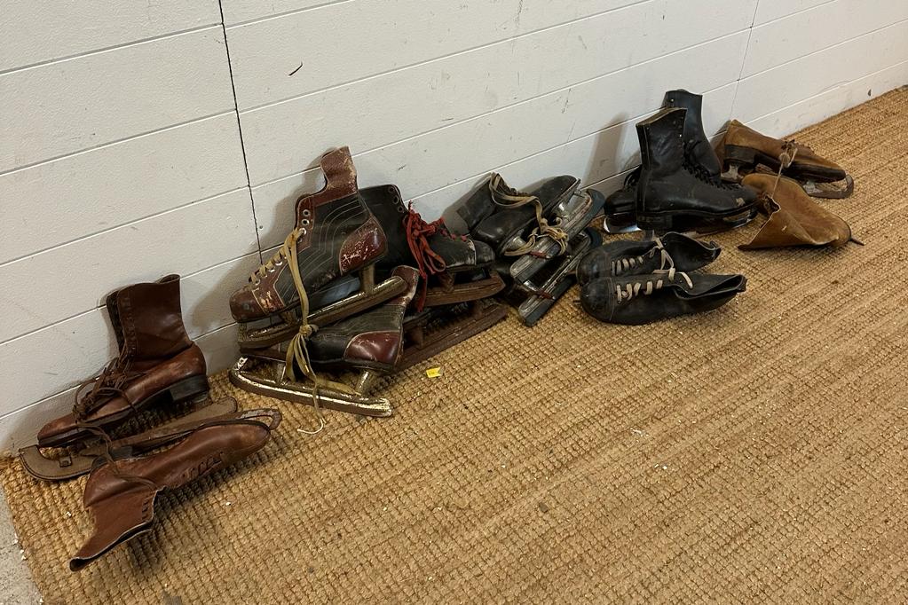 Nine sets of vintage ice skates various styles and sizes