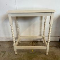 A white painted side table on barley twist legs (H74cm W57cm D33cm)