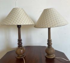 A pair of wooden turned table lamps