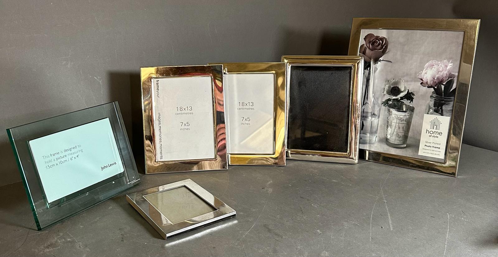 A selection of five white metal photograph frames various sizes along with a John Lewis 6" x 4"