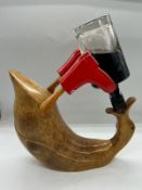 A wooden duck bottle holder