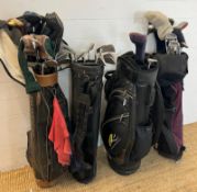 Four golf bags with various clubs