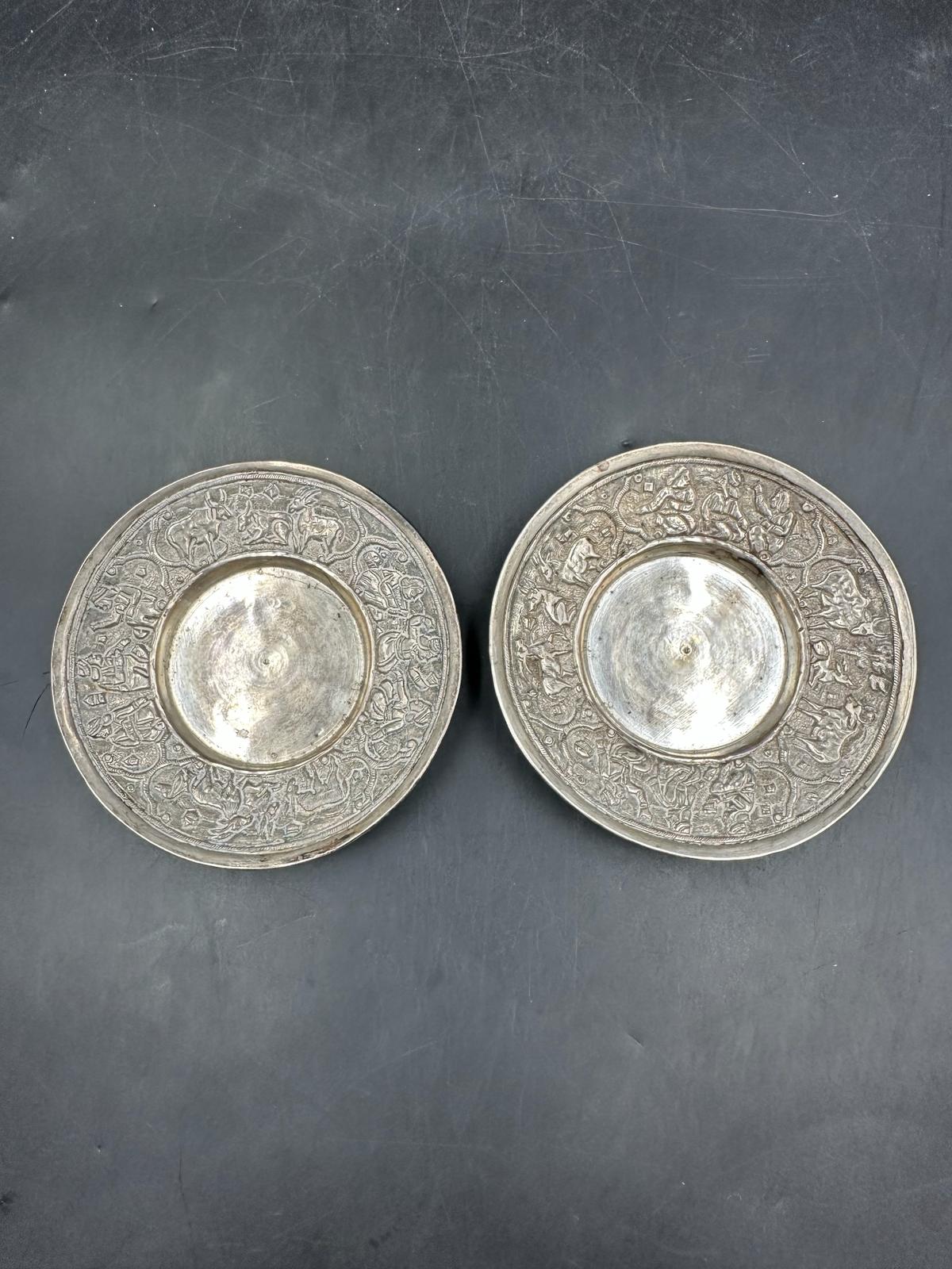 A pair of white metal pin dishes with a nativity scene frieze