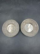 A pair of white metal pin dishes with a nativity scene frieze