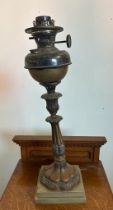 A vintage copper and brass oil lamp on plinth AF