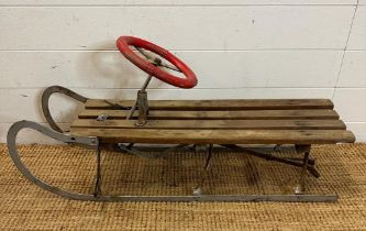 A vintage Rojtos Childs sledge with red steering wheel