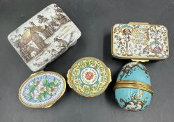 A selection of enamel pill boxes and a ceramic painted pill box
