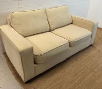 A beige two seater sofa bed AF