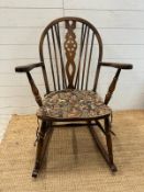 A Mid Century wheel back rocking chair