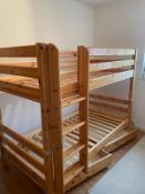 A set of pine bunk beds by Flexa along with a hanging shelf and book holder