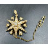 A Victorian star brooch with seed pearl decoration on 15ct yellow gold, with an approximate weight