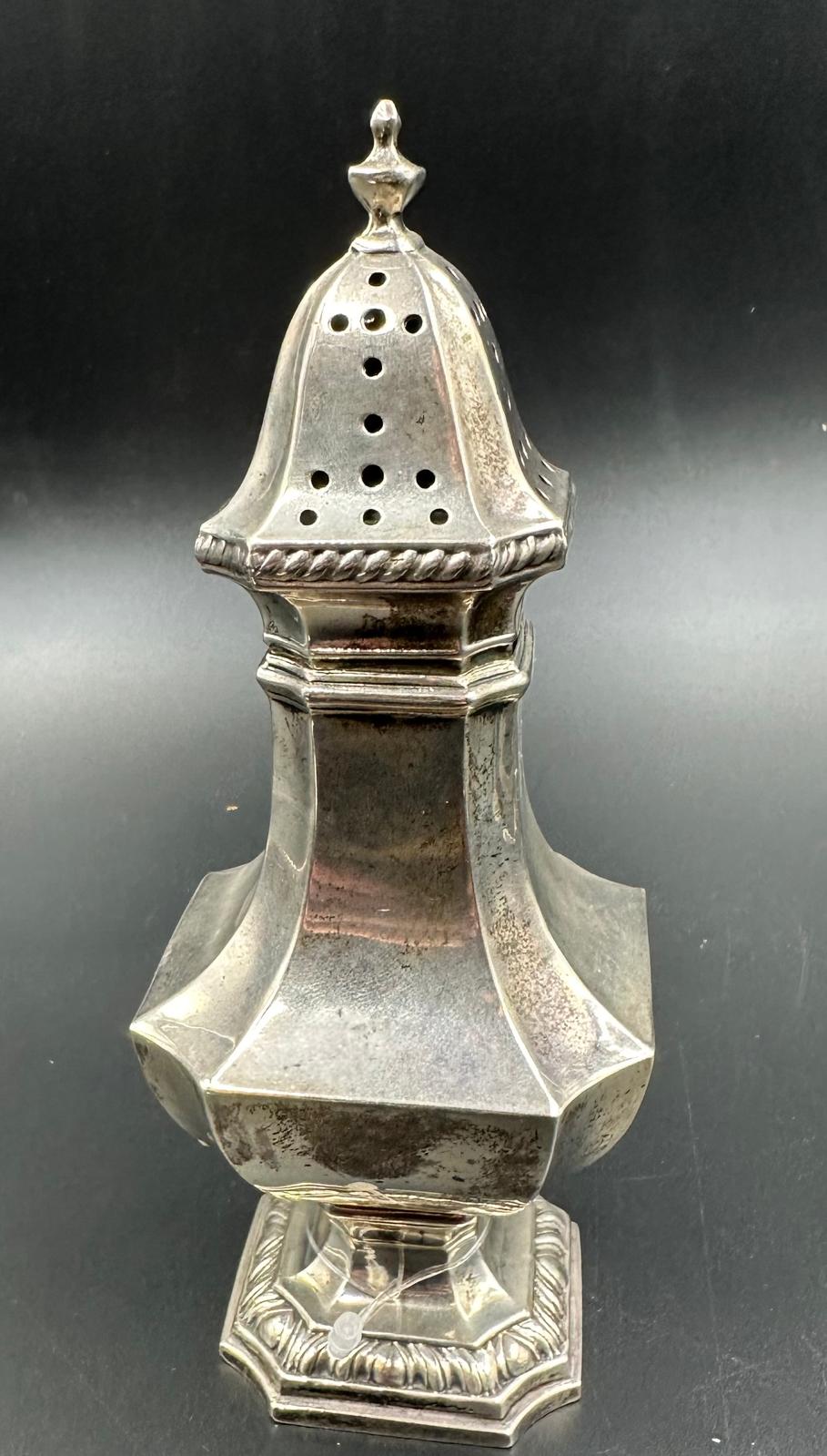 A silver sugar shaker with indistinct hallmarks approximate weight 157g and hallmarked for London