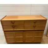 A Mid Century four drawer, two cupboard sideboard by Nathan (H76cm W102cm D45cm)