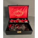 A jewellery box with a variety of costume jewellery.