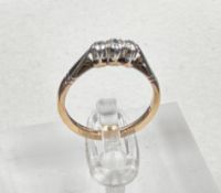 A 9ct gold and platinum three stone diamond ring, size L.