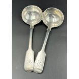 A pair of silver sauce ladles, hallmarked for London by Robert Stebbings 1908. Approximate total