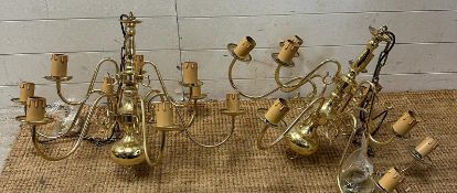 A pair of brass nine arm chandelier ceiling lights
