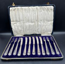 A cased set of six dessert forks and knives with silver handles by Raeno Silver Plate Co Ltd,