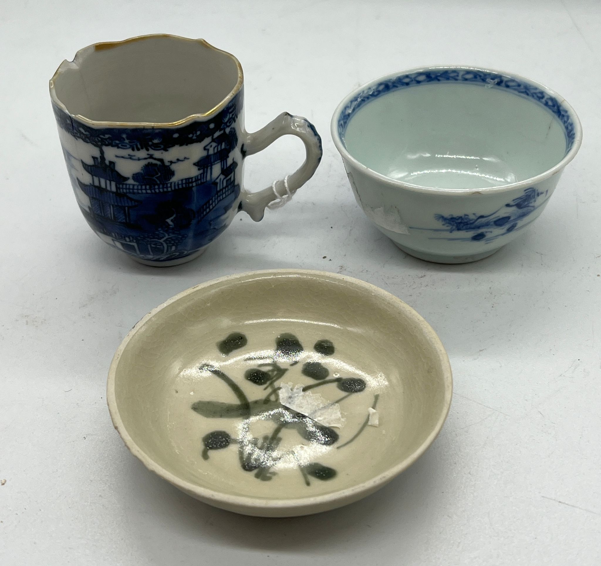 Three pieces of porcelain including cups and saucers