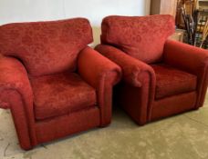 A pair of red floral upholstered arm chairs