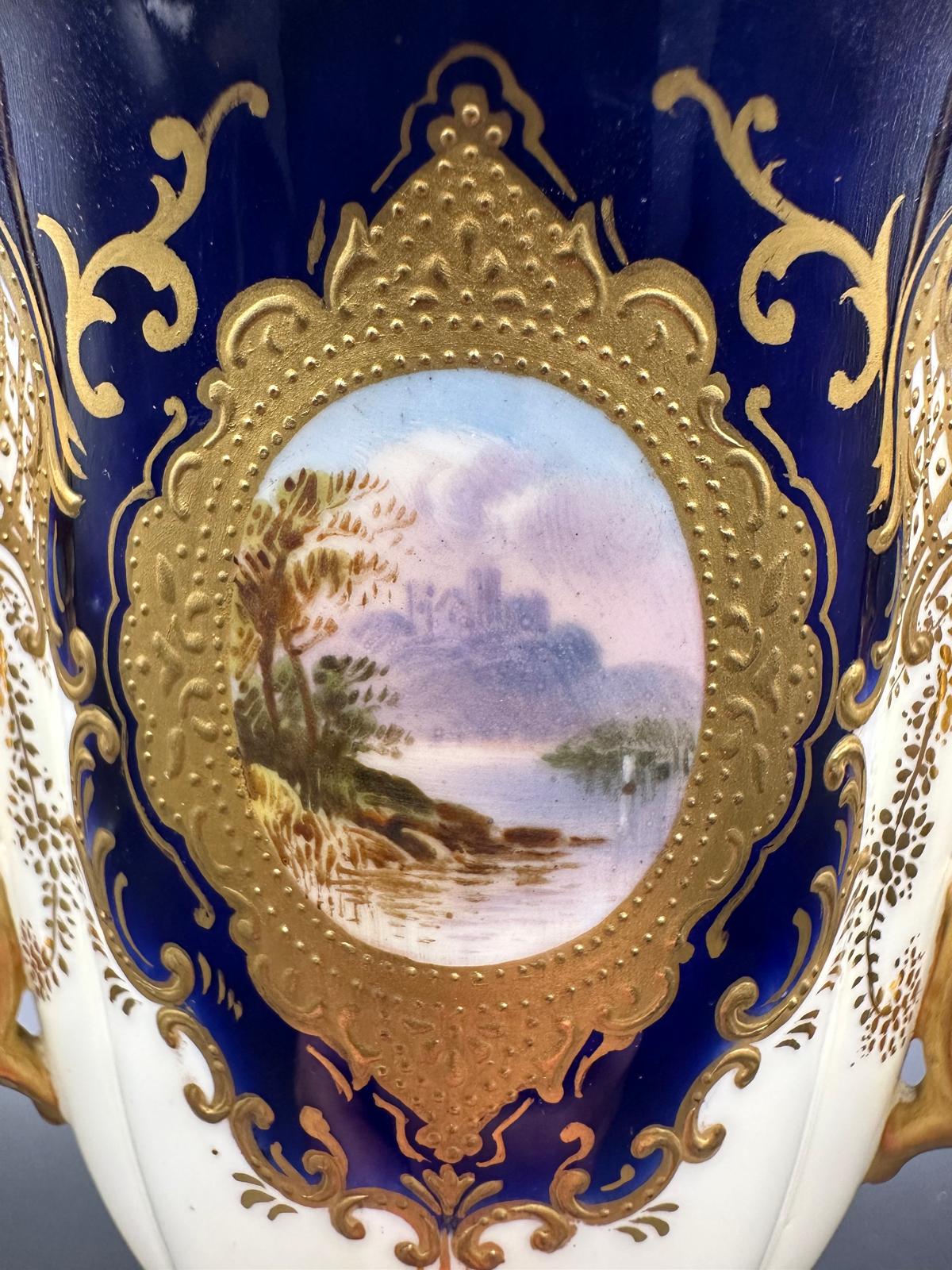 An early 20th Century Coalport, three handled goblet with blue grounds under a acid etch gilt - Image 3 of 5