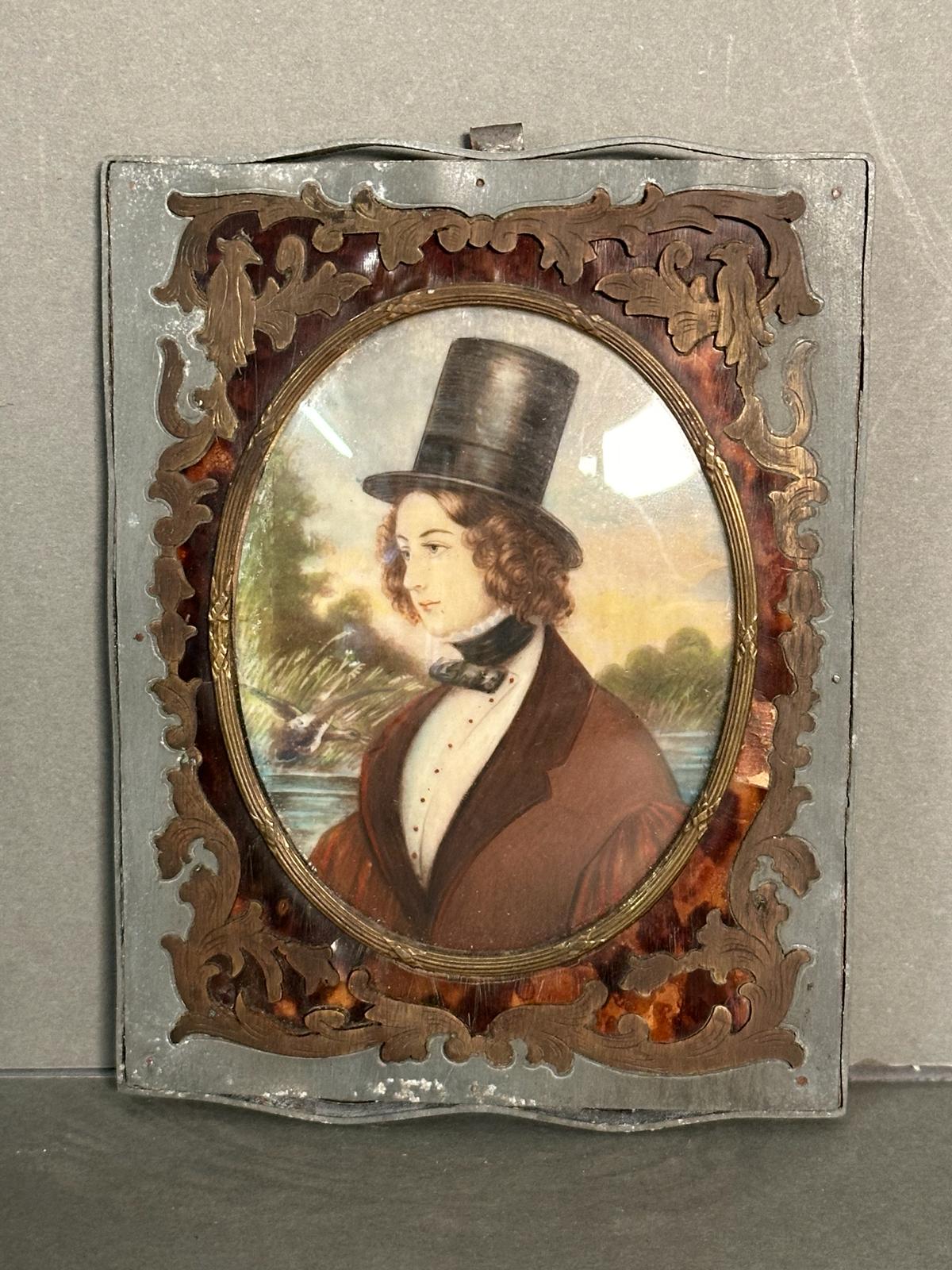 A miniature portrait of a young man in a lead frame with brass and tortoiseshell inlay