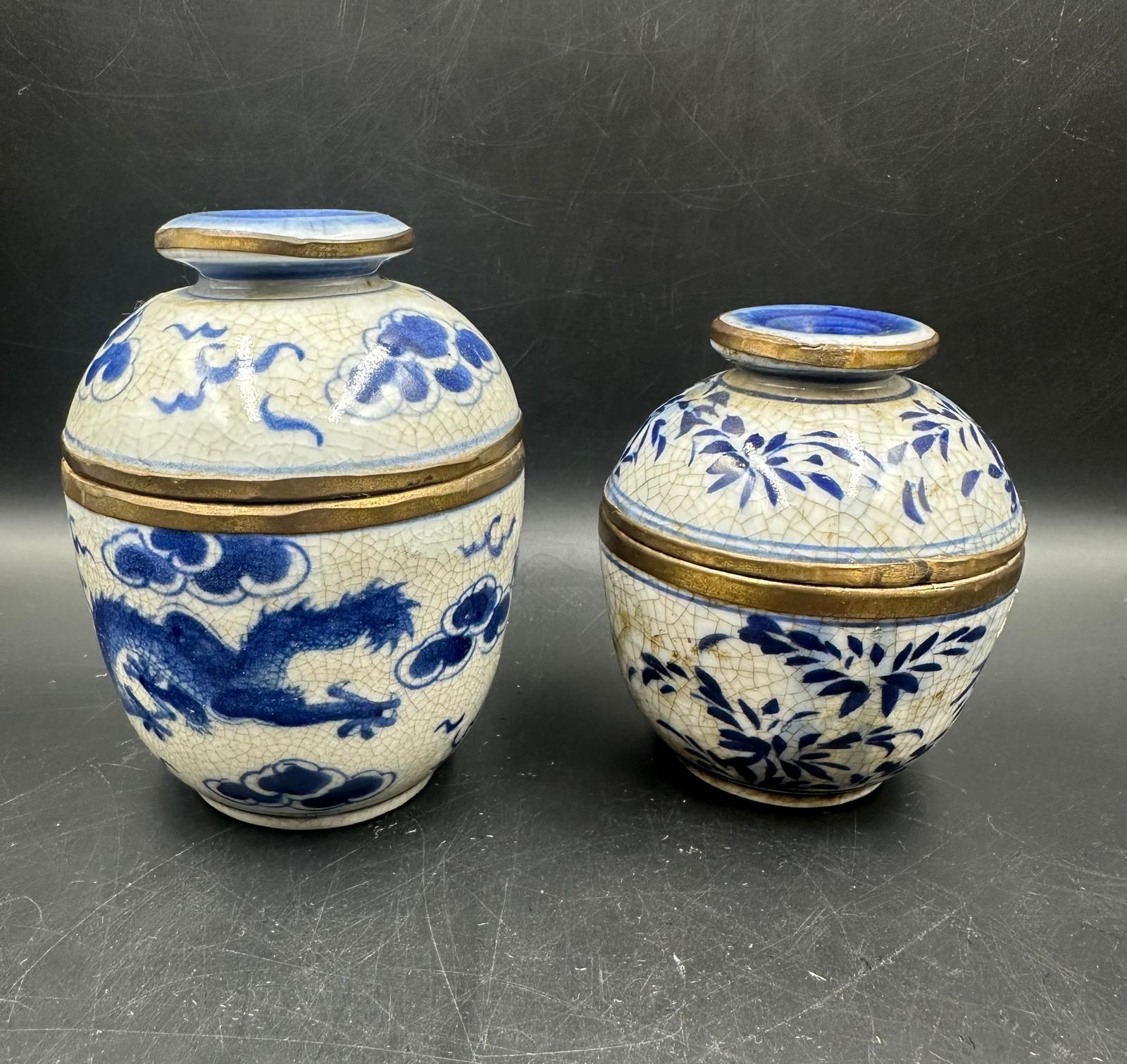 Two blue and white crackle glazed Chinese lidded pots, marked to base