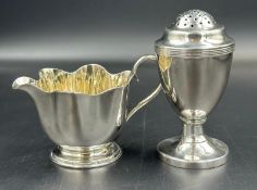 A Mappin & Webb silverplated milk jug and an unmarked pepper pot.