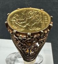 A half sovereign ring in a 9ct gold claw setting Size K