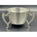 A silver three legged bowl with hammered decoration by George Nathan & Ridley Hayes, hallmarked