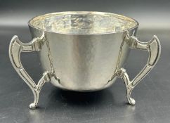 A silver three legged bowl with hammered decoration by George Nathan & Ridley Hayes, hallmarked