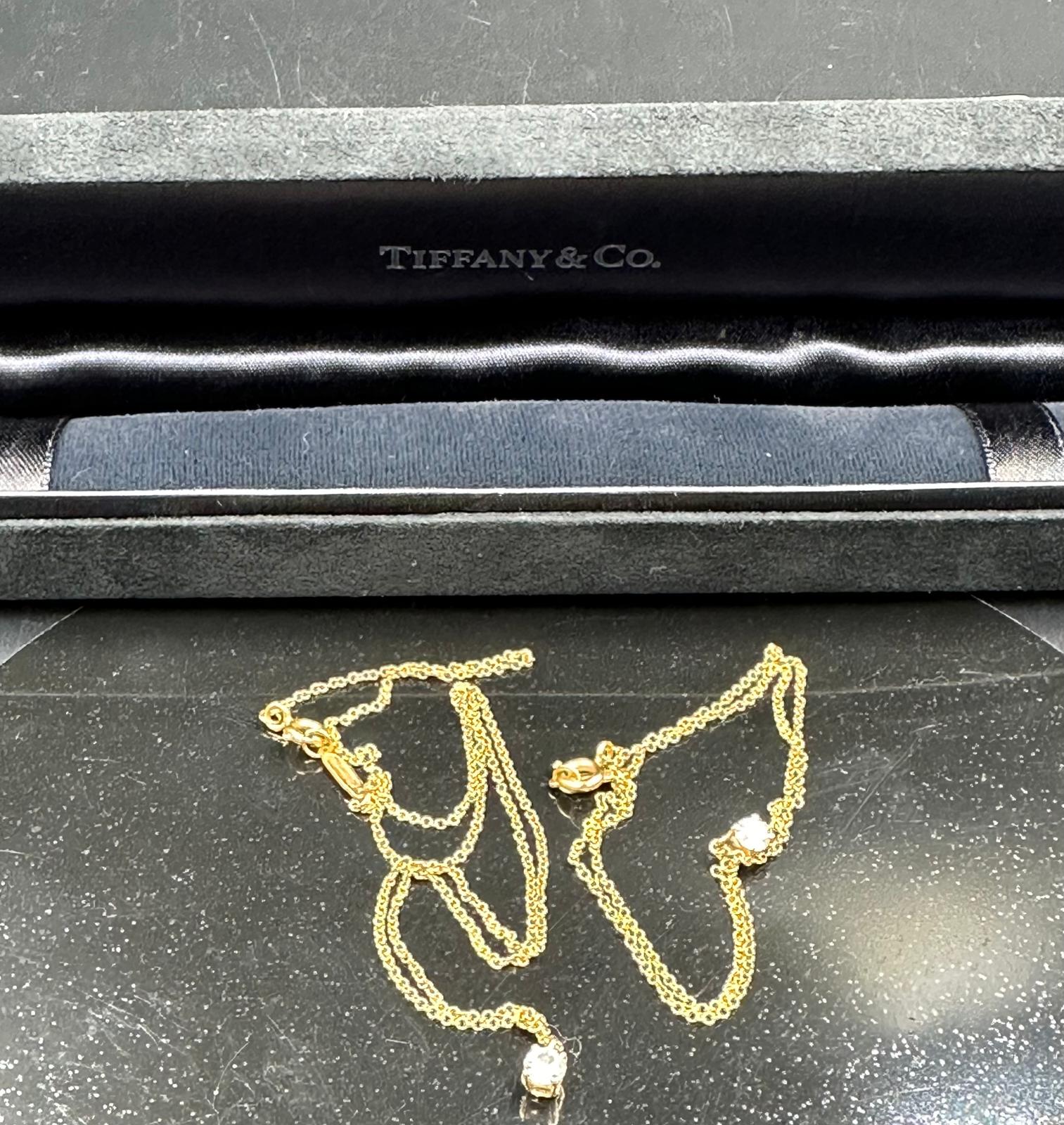 A fine chain necklace with diamond pendant signed Tiffany & Co. on 18ct yellow gold. Combined