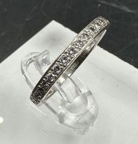 An 18ct white gold wedding band with diamonds, approximately 0.28ct in total, size N