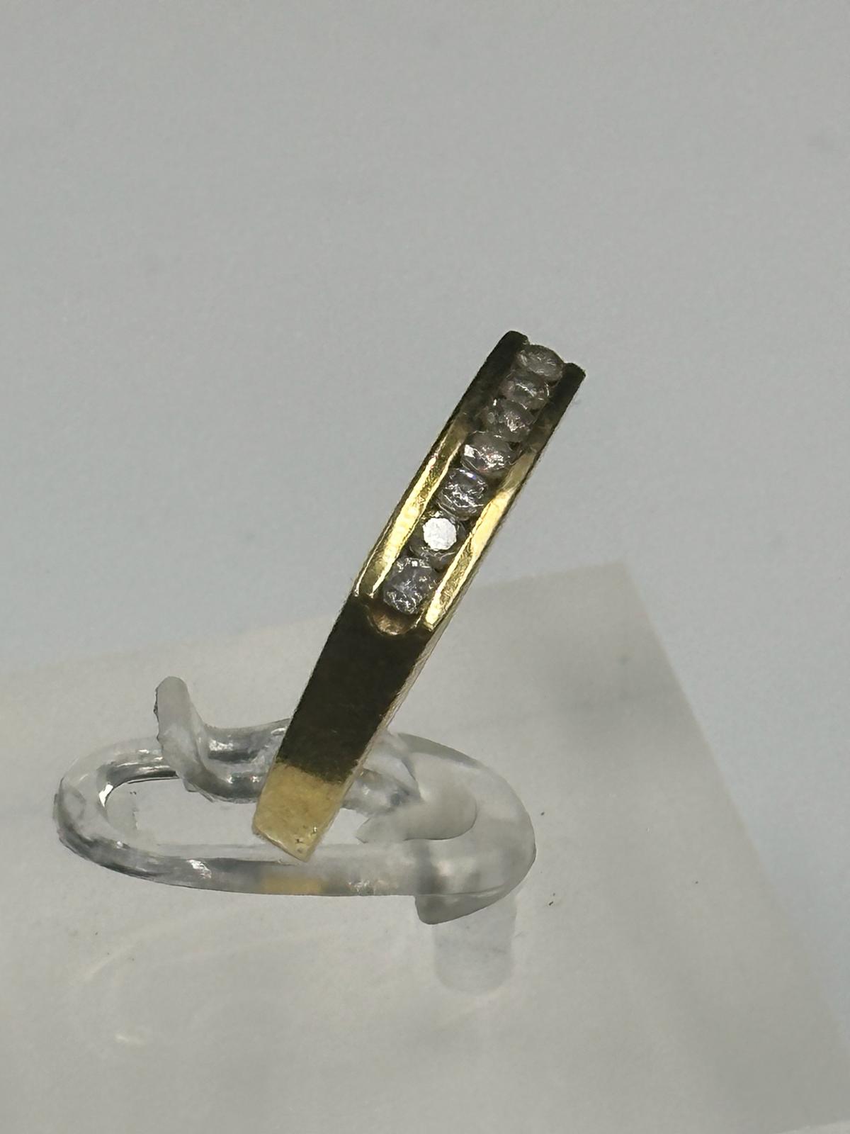 An 18ct gold ring with seven small diamonds and an approximate weight of 4.3g. Size N - Image 3 of 3