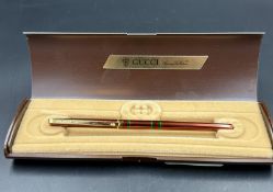 A boxed Gucci pen.