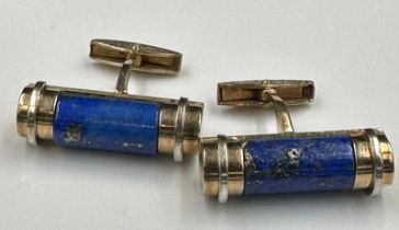 A pair of cylindrical form lapis lazuli gents cuff links on 9ct gold 32mm in width and an
