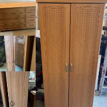 A pine effect bedroom set comprising of two double, one single wardrobe along with a long chest of