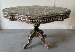 A Moroccan style low pedestal table on splayed legs with geometrical mother of pearl and ebony inlay