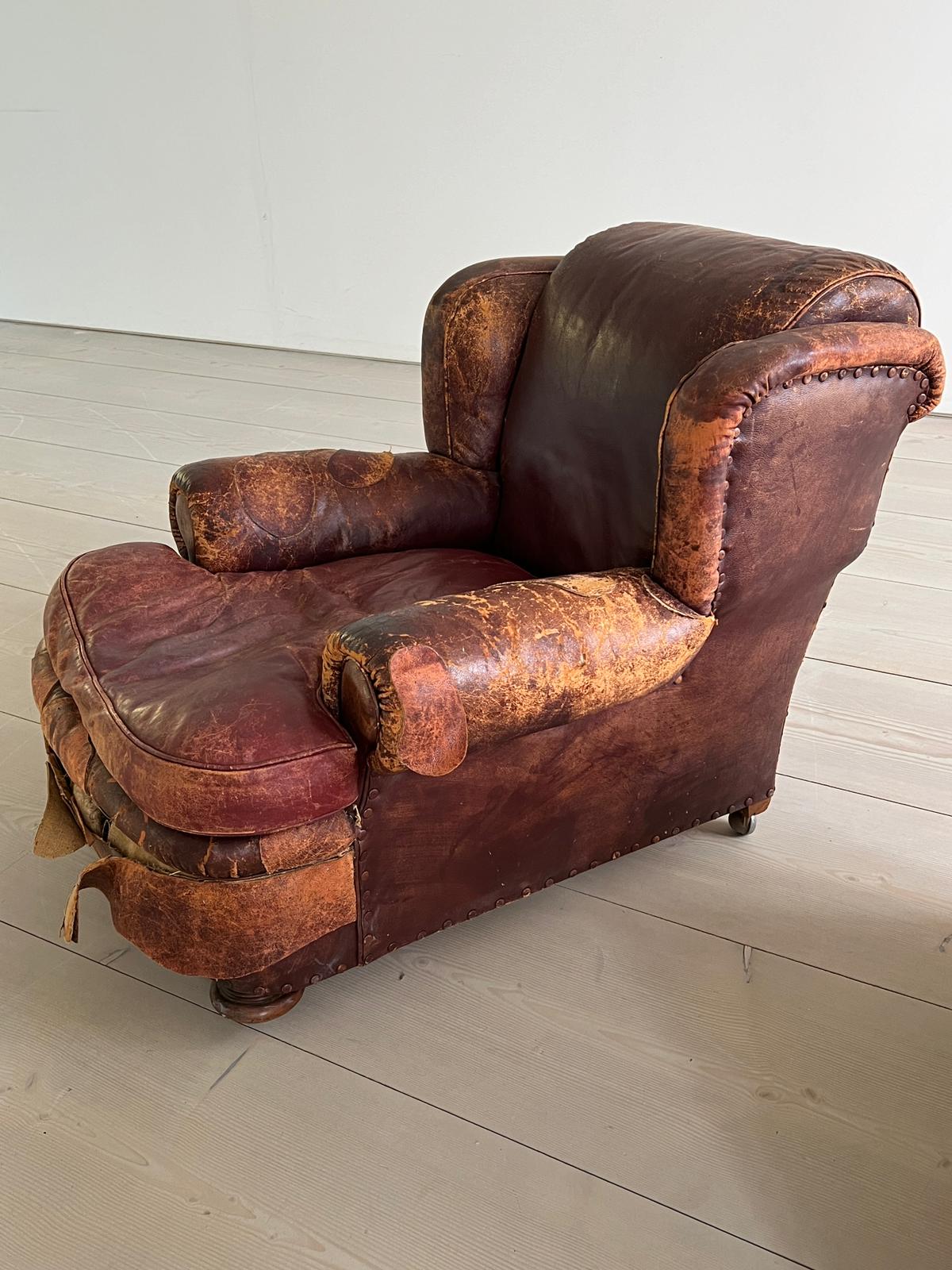 An antique leather club chair in a distressed manner (H84cm W97cm SH37cm) - Image 6 of 7
