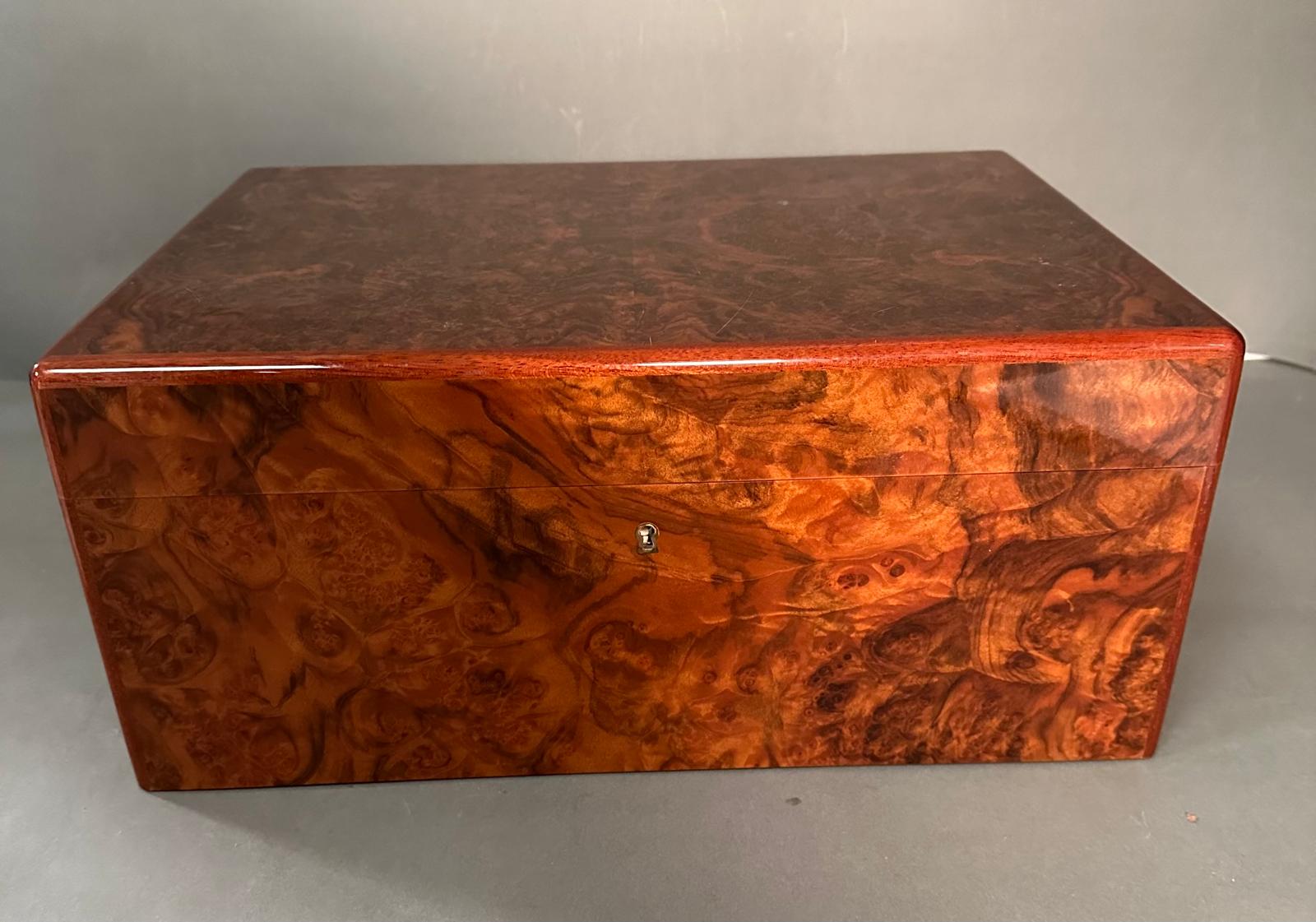 A burr walnut Passatore humidor with cedar veneer and a box of two cigars