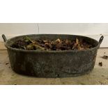 A weathered copper pan used as a planter (H20cm W60cm)