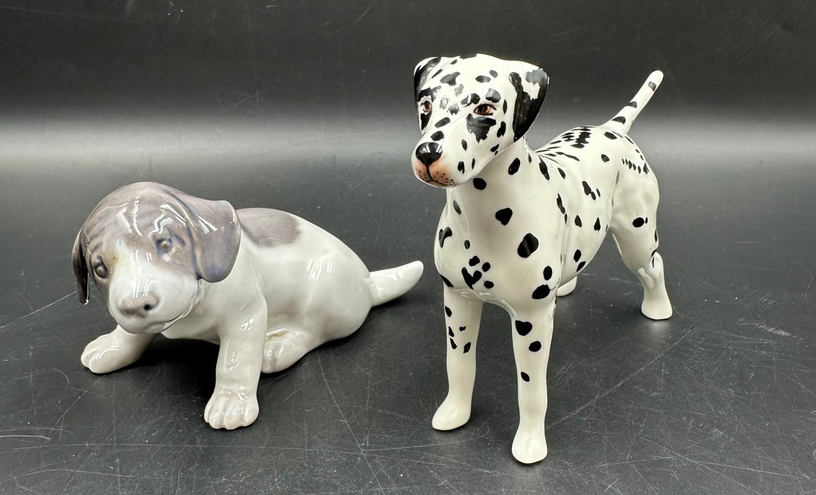 A Beswick figure of a Dalmation dog (8.5cm High) along with a Royal Copenhagen porcelain puppy.
