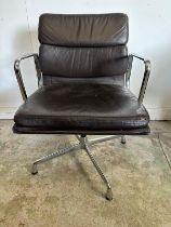 A Vitra Eames soft pad chair with brown leather and chrome open arms