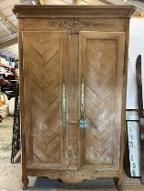 A substantial French style two door wardrobe with star marquetry inlay to crown, etched brass finger