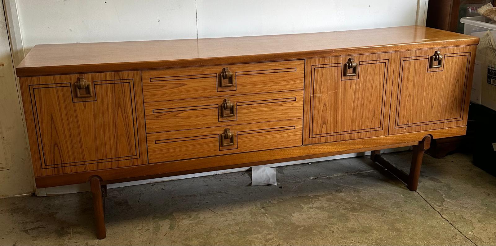 A Mid Century sideboard with string inlay and drop handles (H73cm W184cm D46cm)