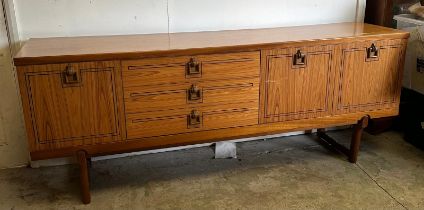 A Mid Century sideboard with string inlay and drop handles (H73cm W184cm D46cm)