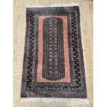 A Pakistani style geometric rug with one central motif with pink grounds 105cm x 95cm